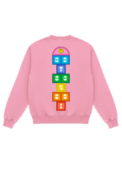 Pink longe sleeve crewneck with colorful hop skotch numbers and a smiley face, flat lay back view