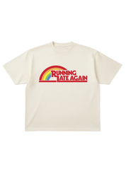 Off white short sleeve tee with red 'RUNNING LATE AGAIN' text and a rainbow, on a white background, flat lay frontal view