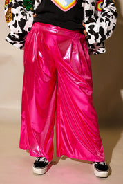 Close up of model wearing pink metallic wide leg pants and sneakers 