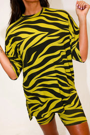 Model wearing a green zebra print short sleeve biker set, on a white background, close up frontal view