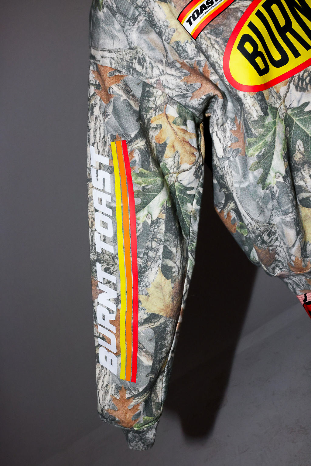 Camouflage crewneck with 'Burnt toast' branding on a dark background