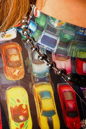 Close-up of a colorful keychain with a long sleeve mesh top, with car designs