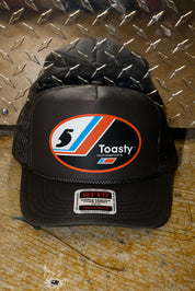 Grey trucker with a logo on a metallic surface, frontal view