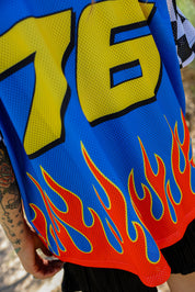 Blue mesh jersey with number 76 in yellow and red flames design, close up frontal view