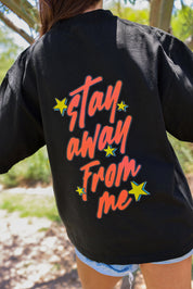 Black shirt with 'Stay Away From Me' text on the back, worn outdoors, back view