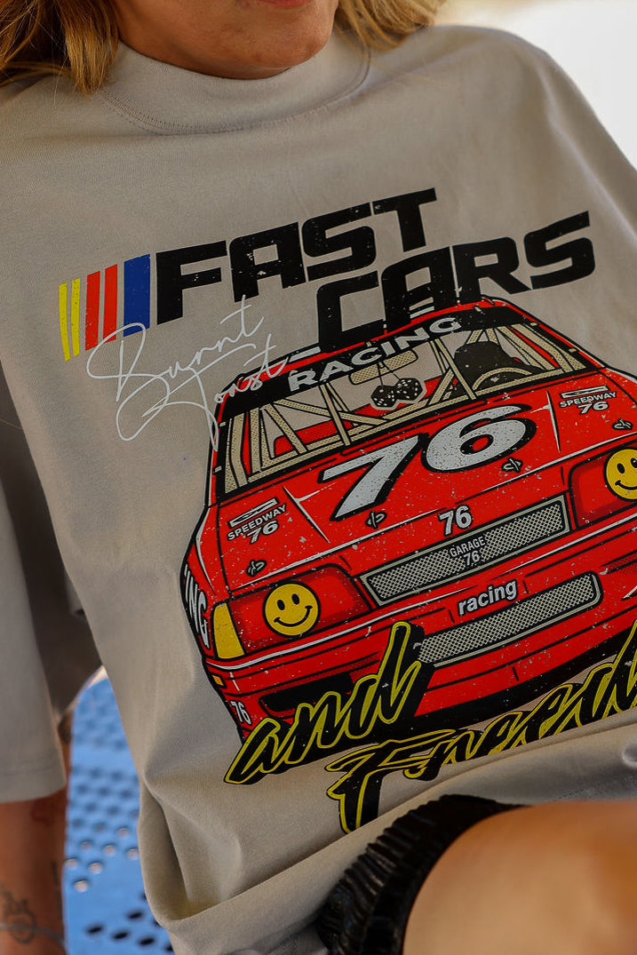 Graphic tee shirt with a red race car graphic and text on a light gray background