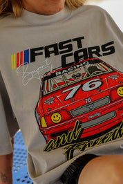 Graphic tee shirt with a red race car graphic and text on a light gray background