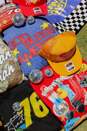 Collection of colorful t-shirts and hats with various designs and text