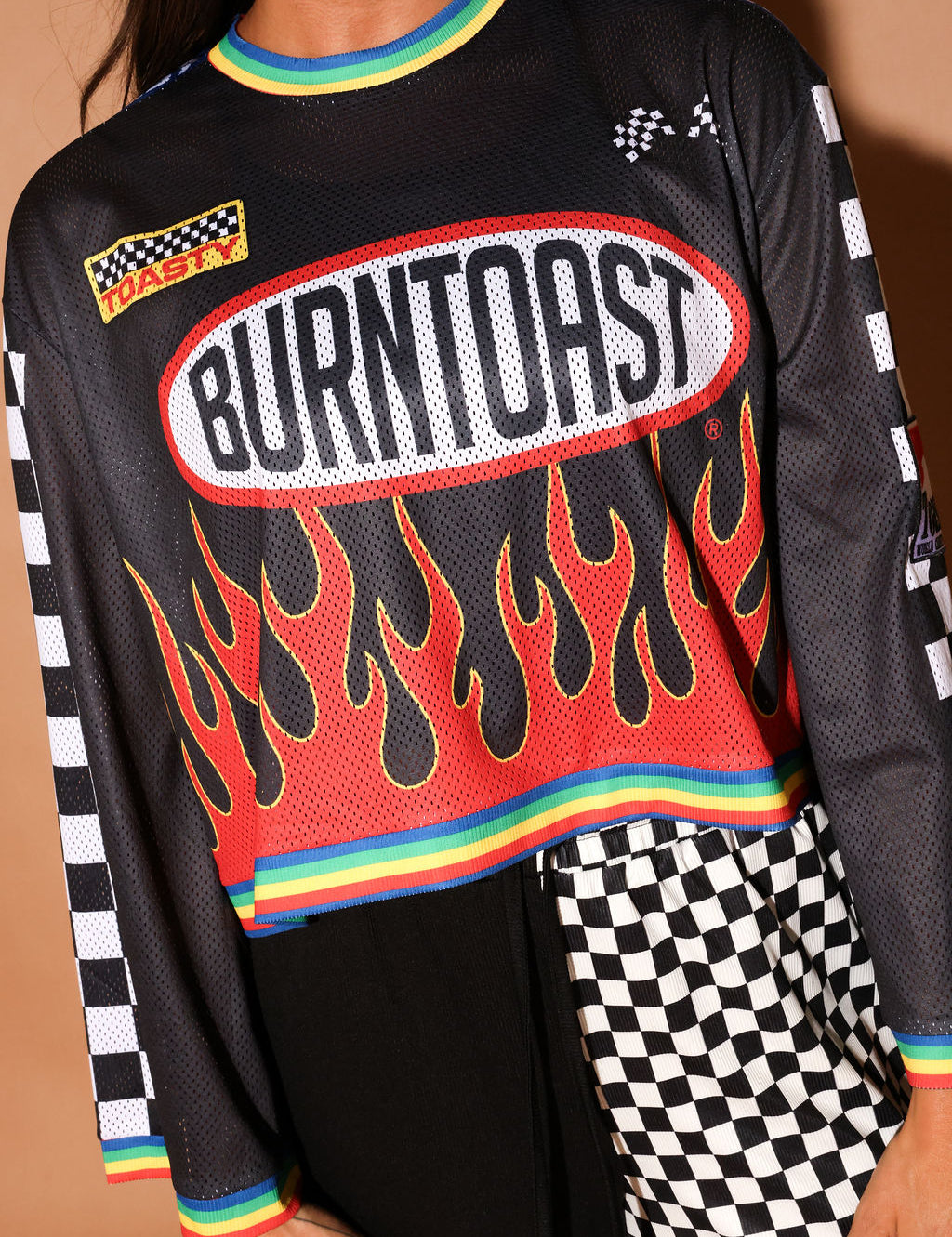 Black long-sleeve mesh jersey with 'Burntoast' logo and flames design, worn by a person, close up frontal view
