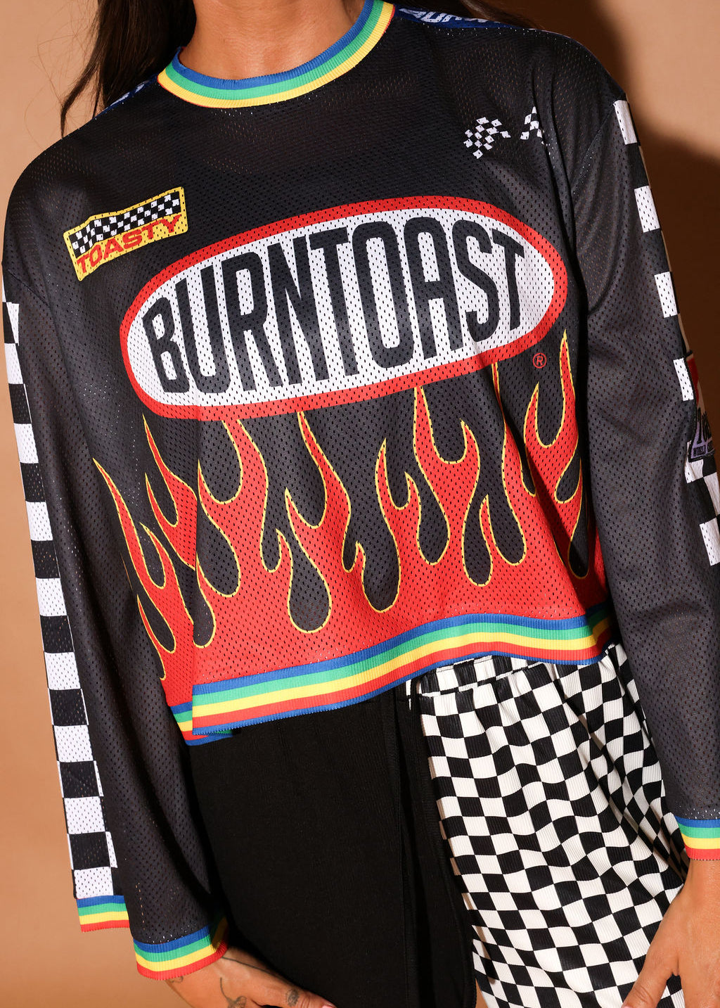 Black long-sleeve mesh jersey with 'Burntoast' logo and flames design, worn by a person, close up frontal view