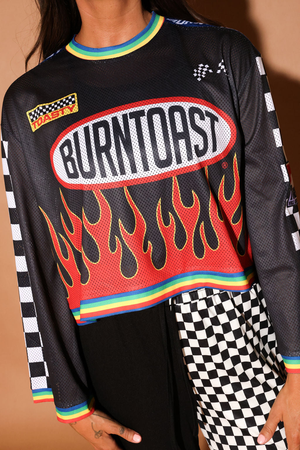 Black long-sleeve mesh jersey with 'Burntoast' logo and flames design, worn by a person, close up frontal view