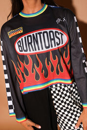 Black long-sleeve mesh jersey with 'Burntoast' logo and flames design, worn by a person, close up frontal view