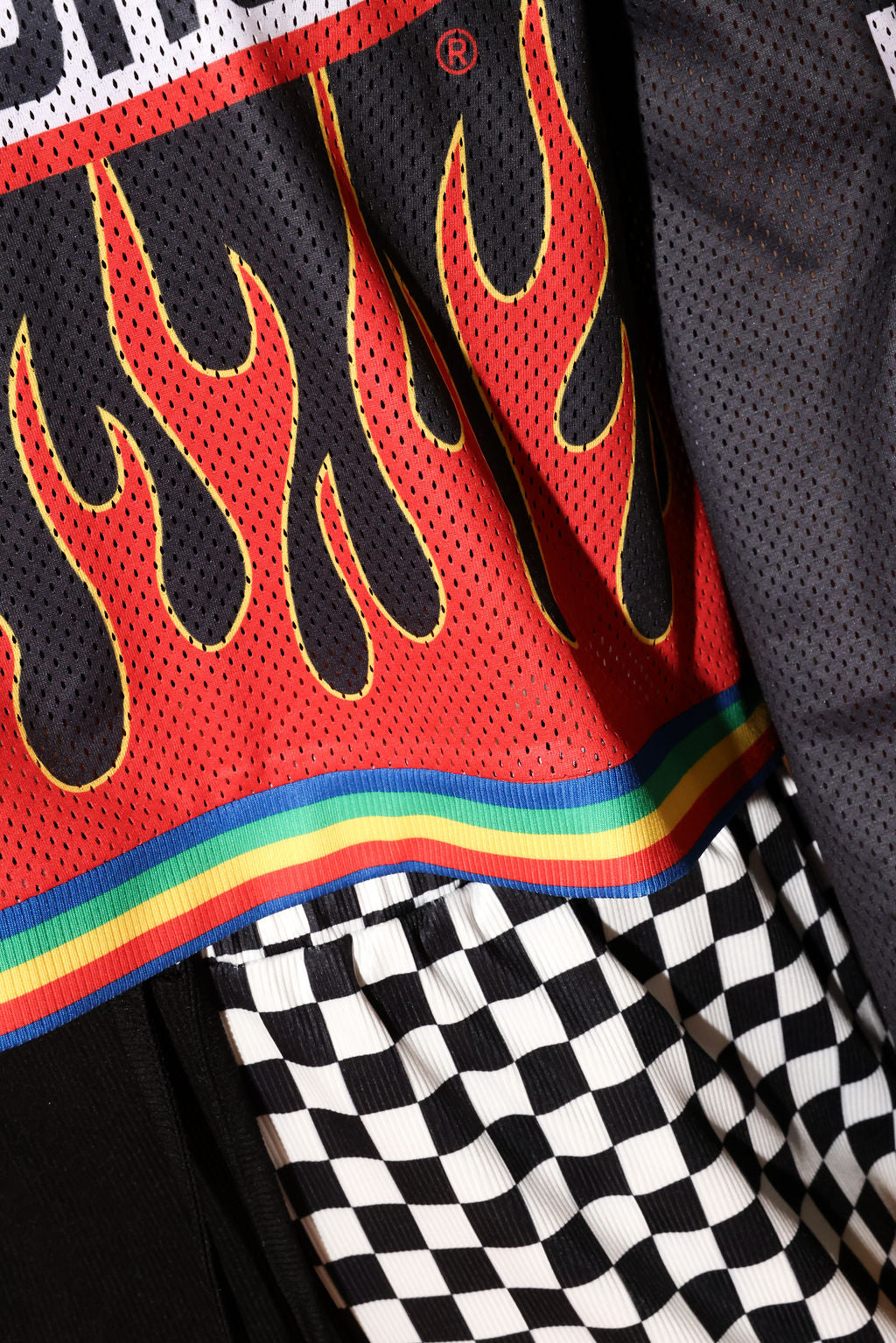 Close-up of a sports jersey with flame design and rainbow stripe