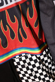 Close-up of a sports jersey with flame design and rainbow stripe