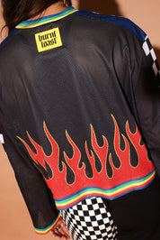 Model wearing a black sports jersey with flames and a brand logo on the back, close up back view