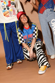 3 people posing, wearing 4th of july themed outfits, on a beige background, frontal view