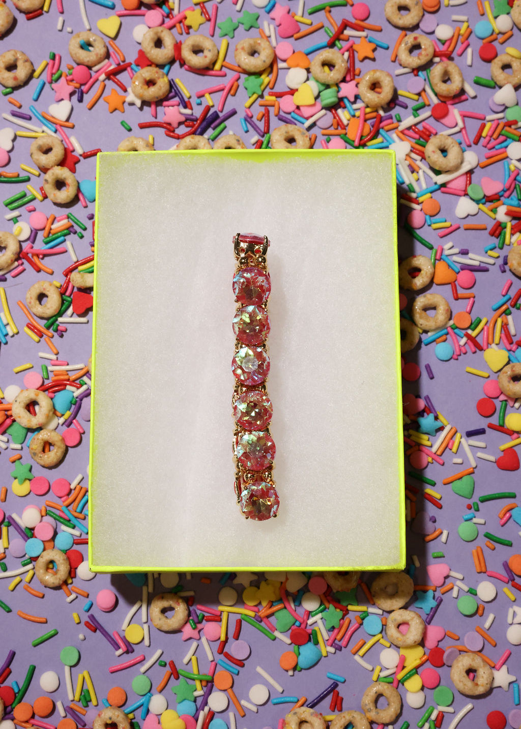 Bracelet on a yellow card with colorful cereal and sprinkles in the background