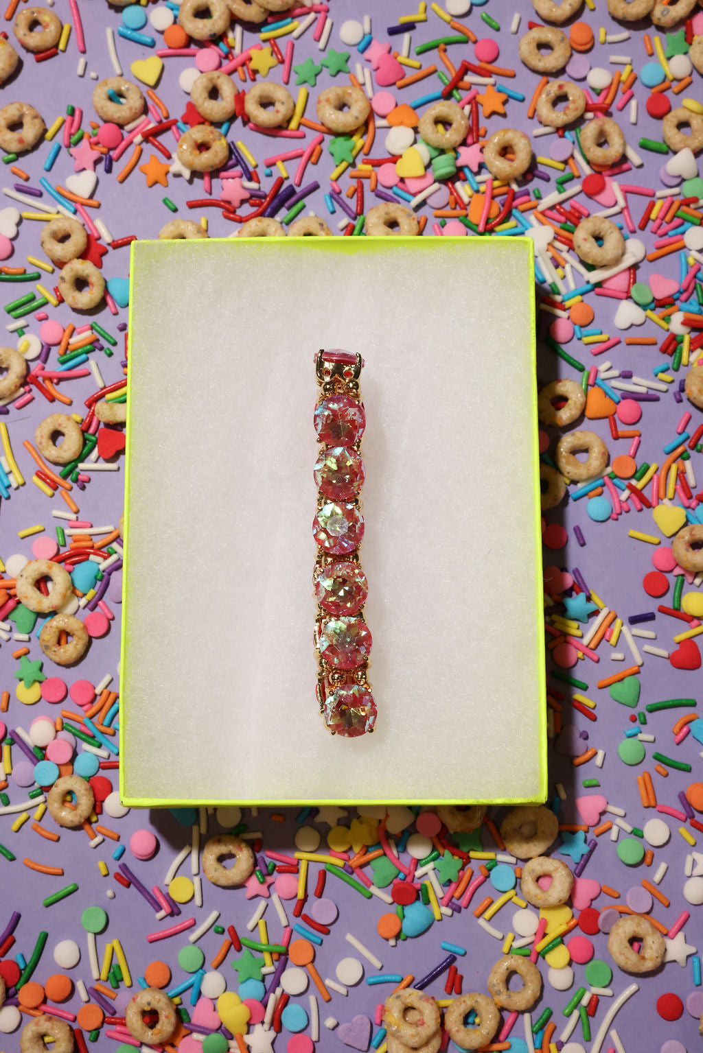 Bracelet on a yellow card with colorful cereal and sprinkles in the background