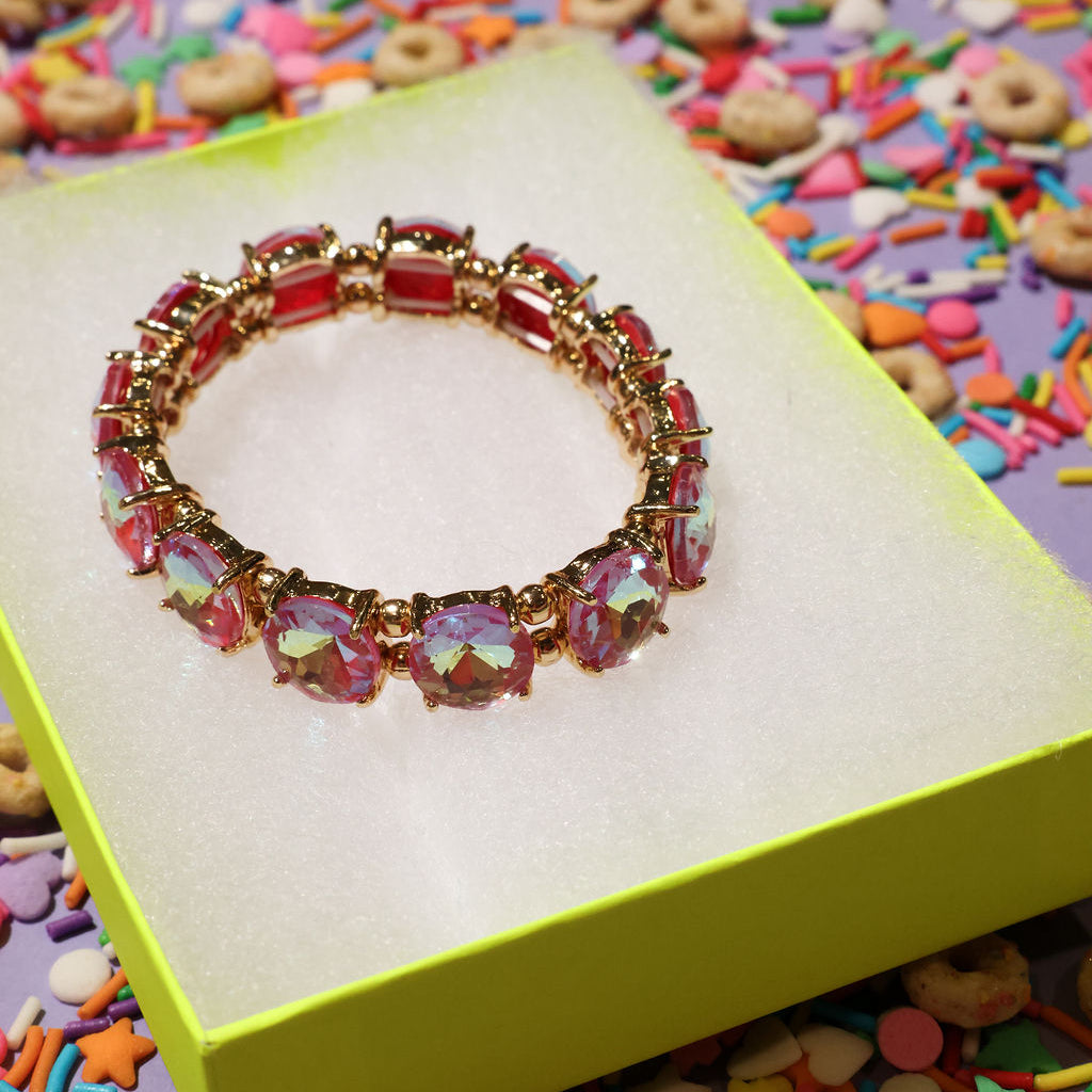 Colorful bracelet on a yellow box with colorful sprinkles in the background