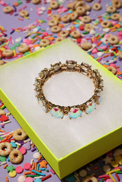 Decorative bracelet on a colorful box with cereal-themed background