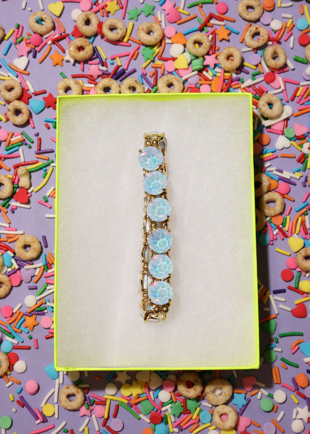 Decorative hair barrette with blue flowers on a colorful sprinkles background
