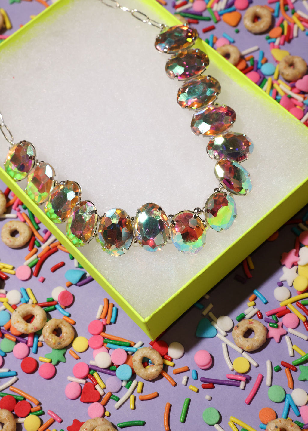 Colorful beaded bracelet on a box with colorful sprinkles and cereal in the background