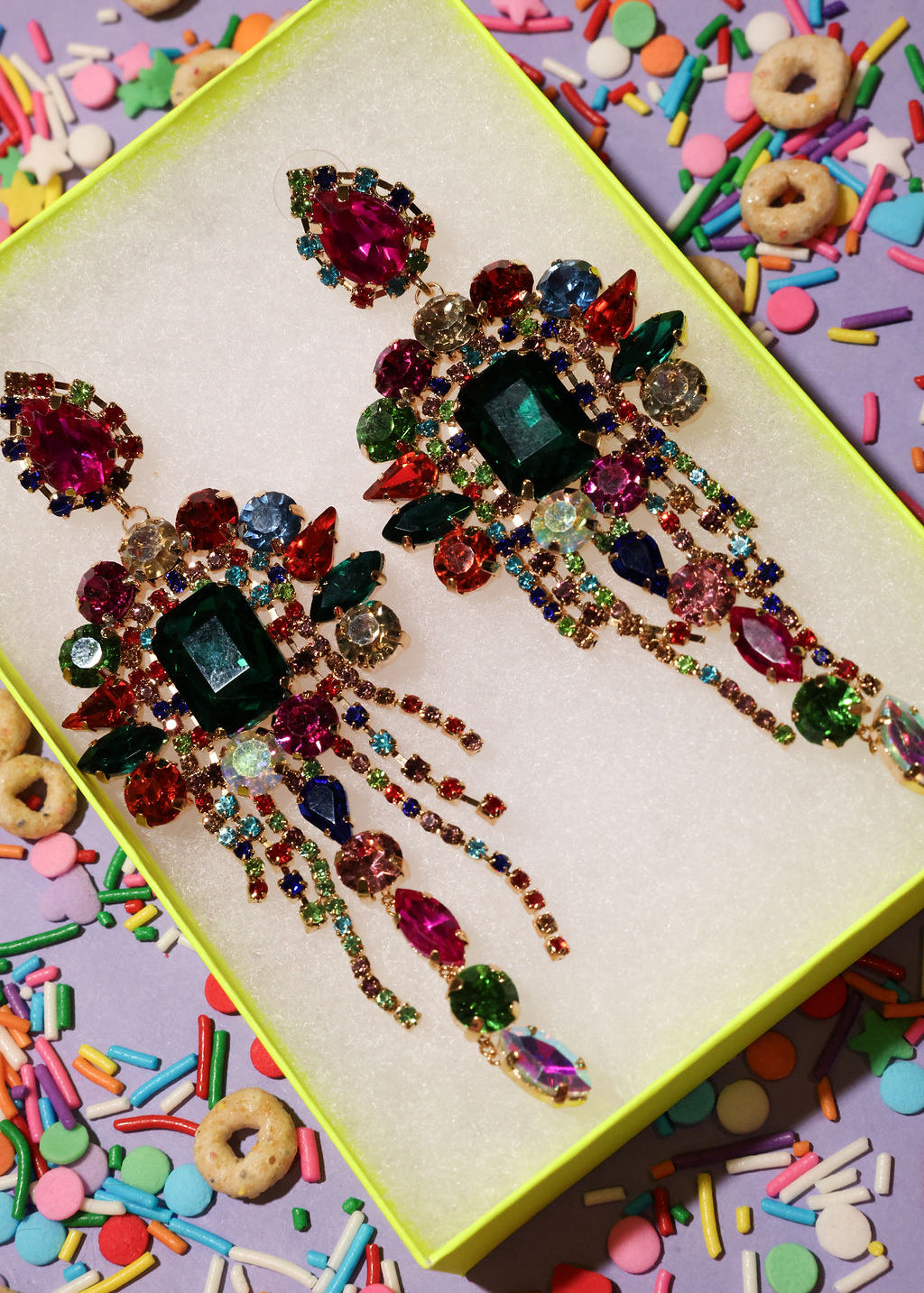 Colorful jeweled hair pins on a box with colorful sprinkles and cereal in the background