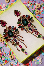 Colorful jeweled hair pins on a box with colorful sprinkles and cereal in the background
