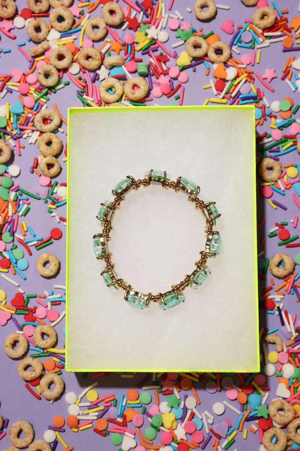 Bracelet on a yellow card with colorful cereal and sprinkles in the background