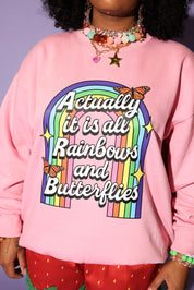 Person wearing a pink sweatshirt with rainbow text and butterfly graphics