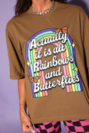 Brown t-shirt with rainbow and butterfly design on a purple background, close up frontal view