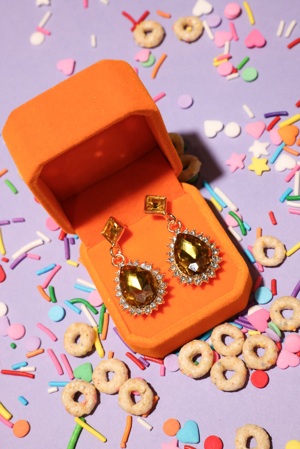 Jewelry box with diamond earrings on a colorful background