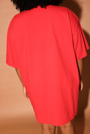 Model wearing a red t-shirt on a white background, back view