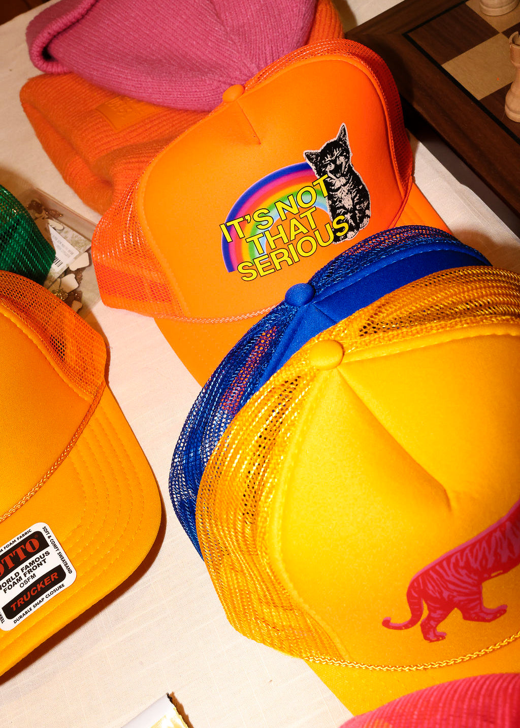 A collection of colorful trucker hats on a white surface