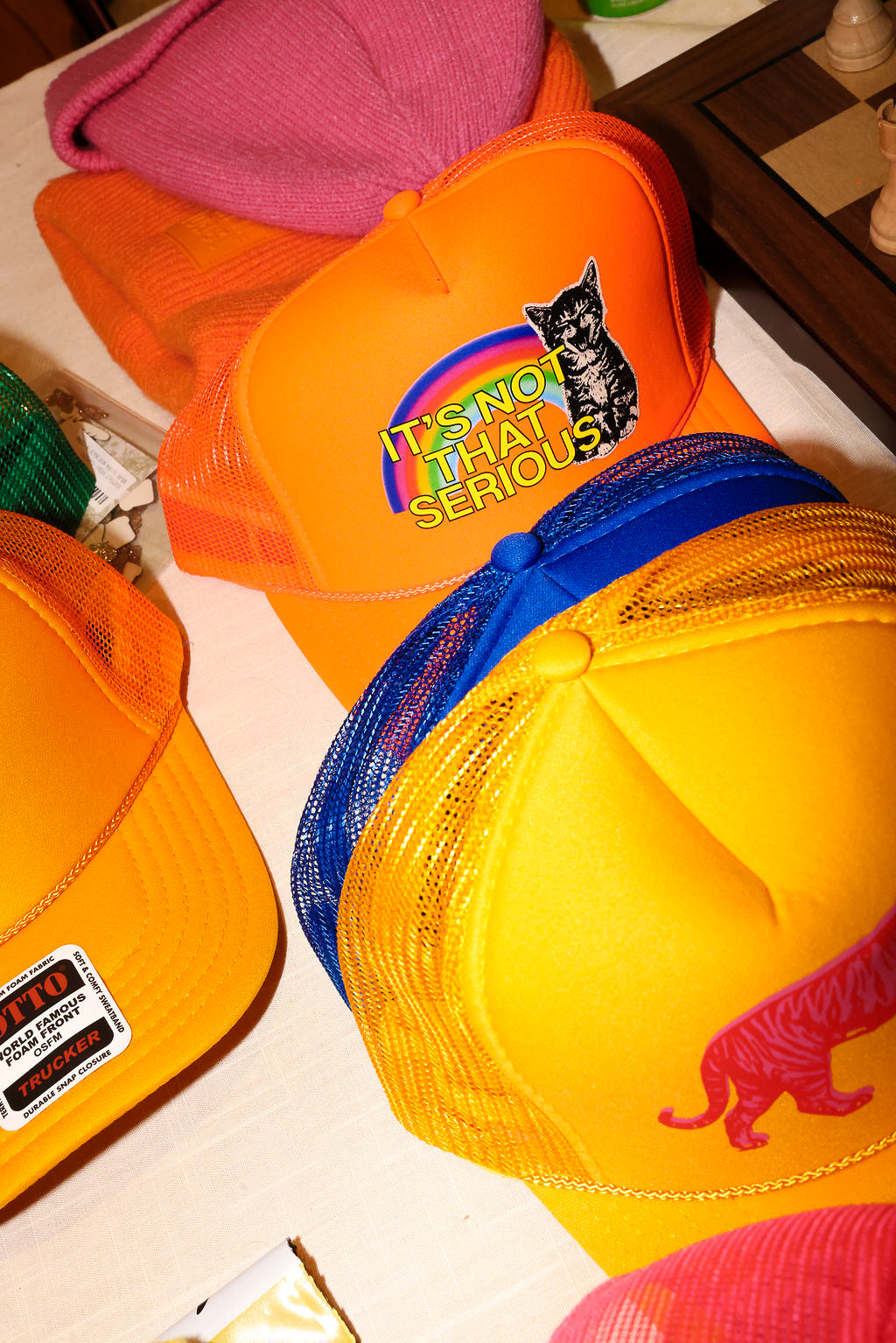 A collection of colorful trucker hats on a white surface