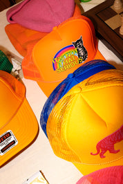 A collection of colorful trucker hats on a white surface