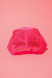 Back view of a neon pink trucker hat on a pink background