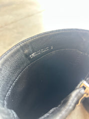 Close-up of the interior lining of a black leather or faux-leather bag, showing the size 9