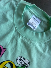 A close-up of a mint green t-shirt showing the inner neck label which reads 'Pina-Wear' and '28th Street Ave. XL'.