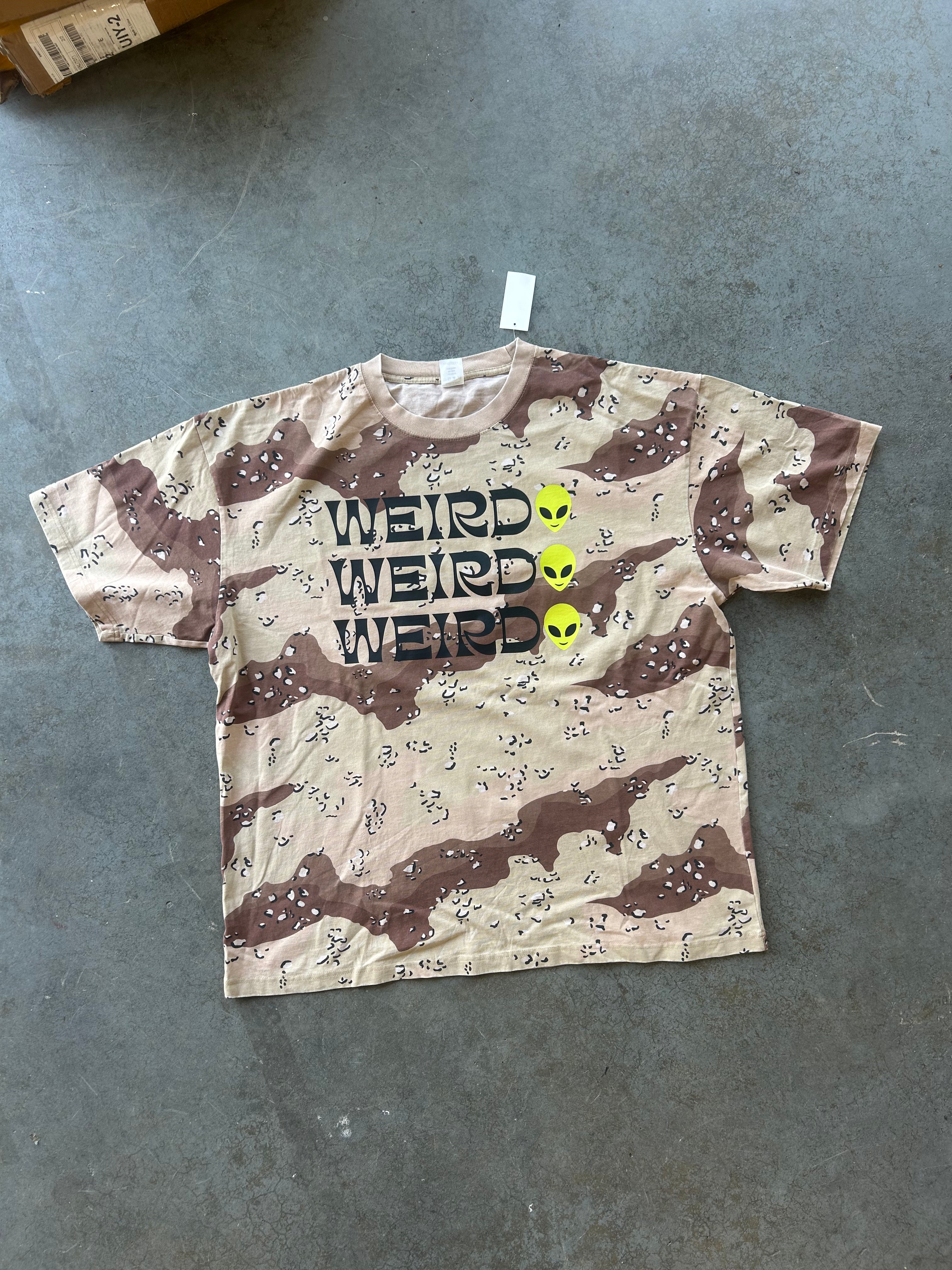 Camo graphic tee with WIERD Alien 3 times on a concrete surface