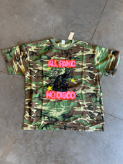 Short sleeve camo tee with graphic on the front on a concrete surface