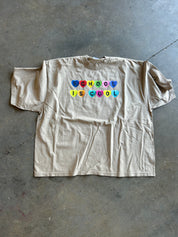 Oatmeal colored graphic that says School is Cool In candy hearts on a concrete Surface