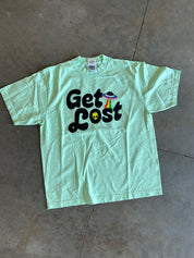 Seafoam green tee with 'Get Lost' text in black on a concrete surface