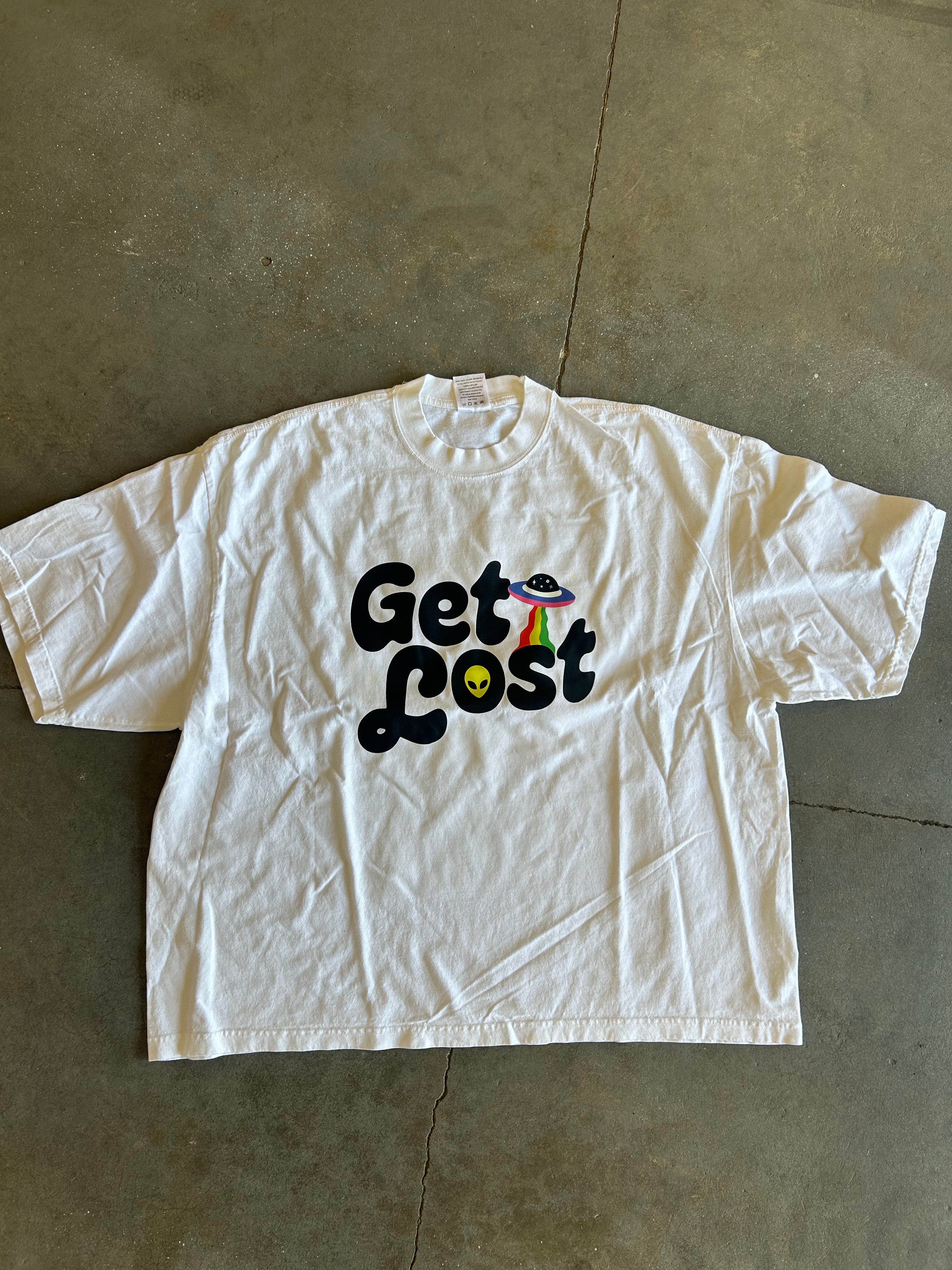 Get Lost graphic on a ivory tee on a concrete surface