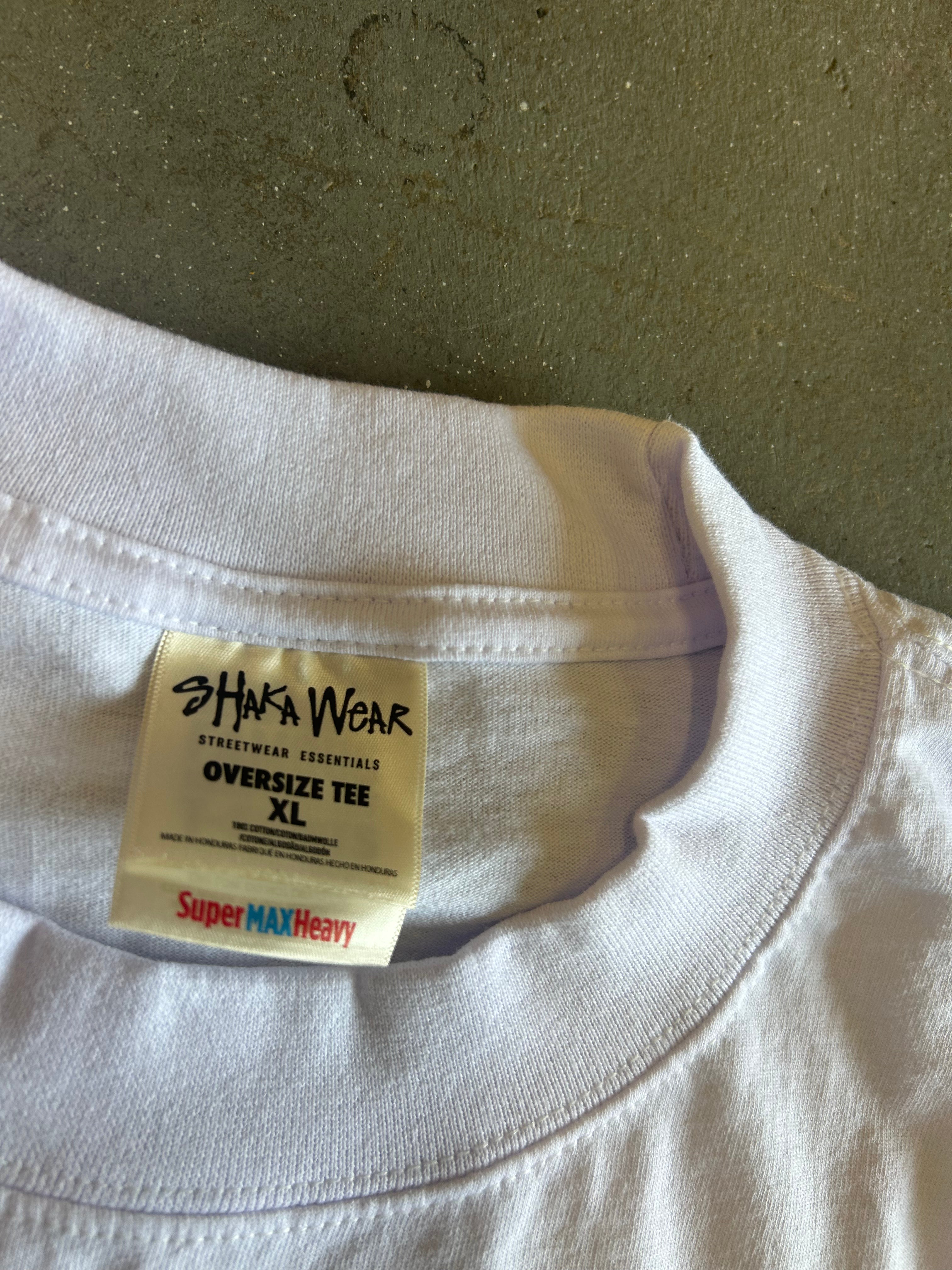 Close-up of a white oversized t-shirt collar showing the inner neck label for 'Haka Wear' and 'Super MAX Heavy'.