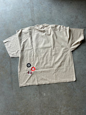 Back of a tshirt that has 8 ball design, flat lay view on a concrete