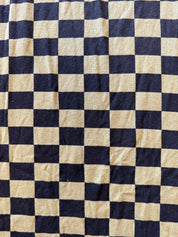 A close-up of a fabric with a black and green checkerboard pattern