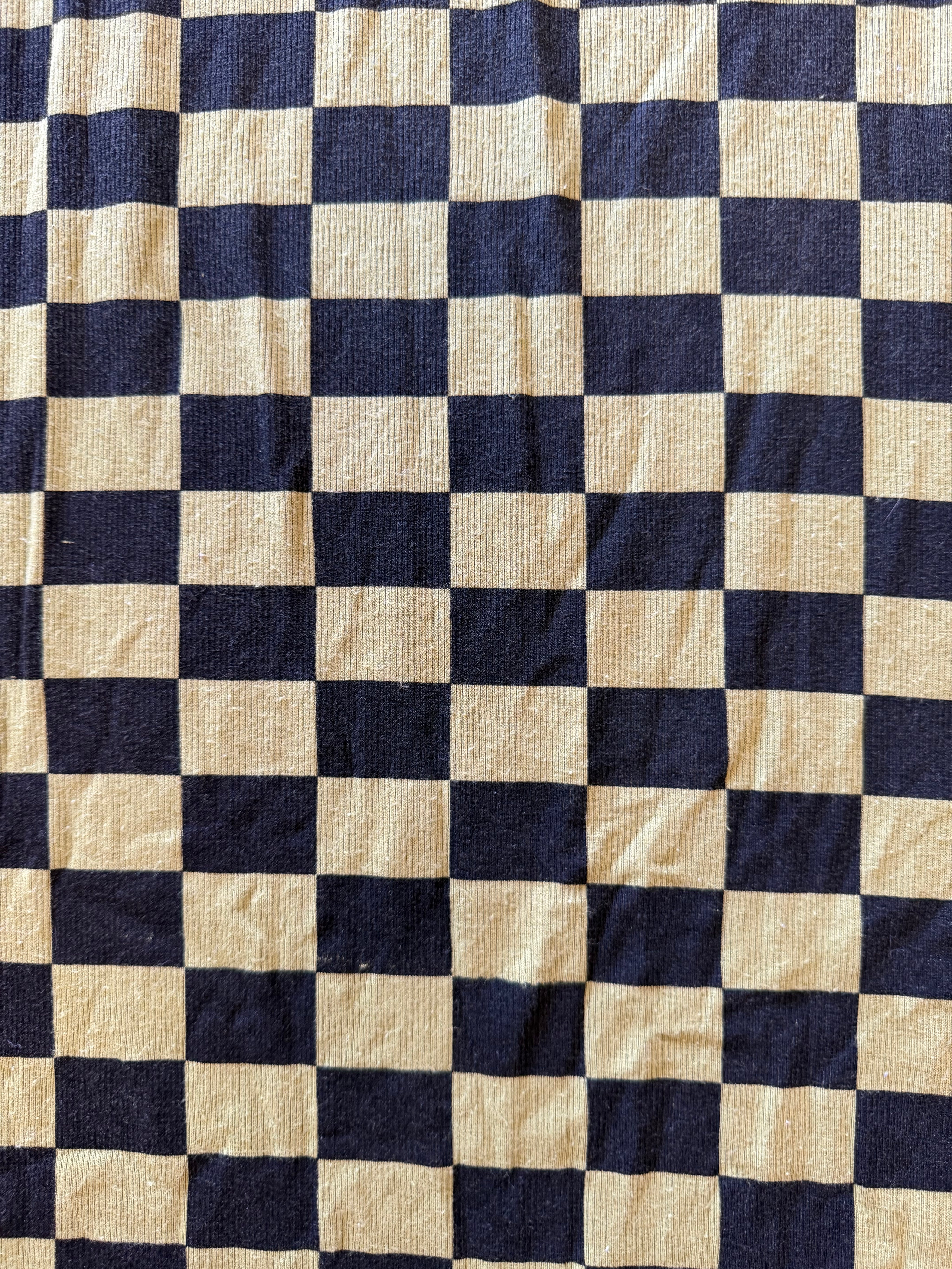 A close-up of a fabric with a black and green checkerboard pattern