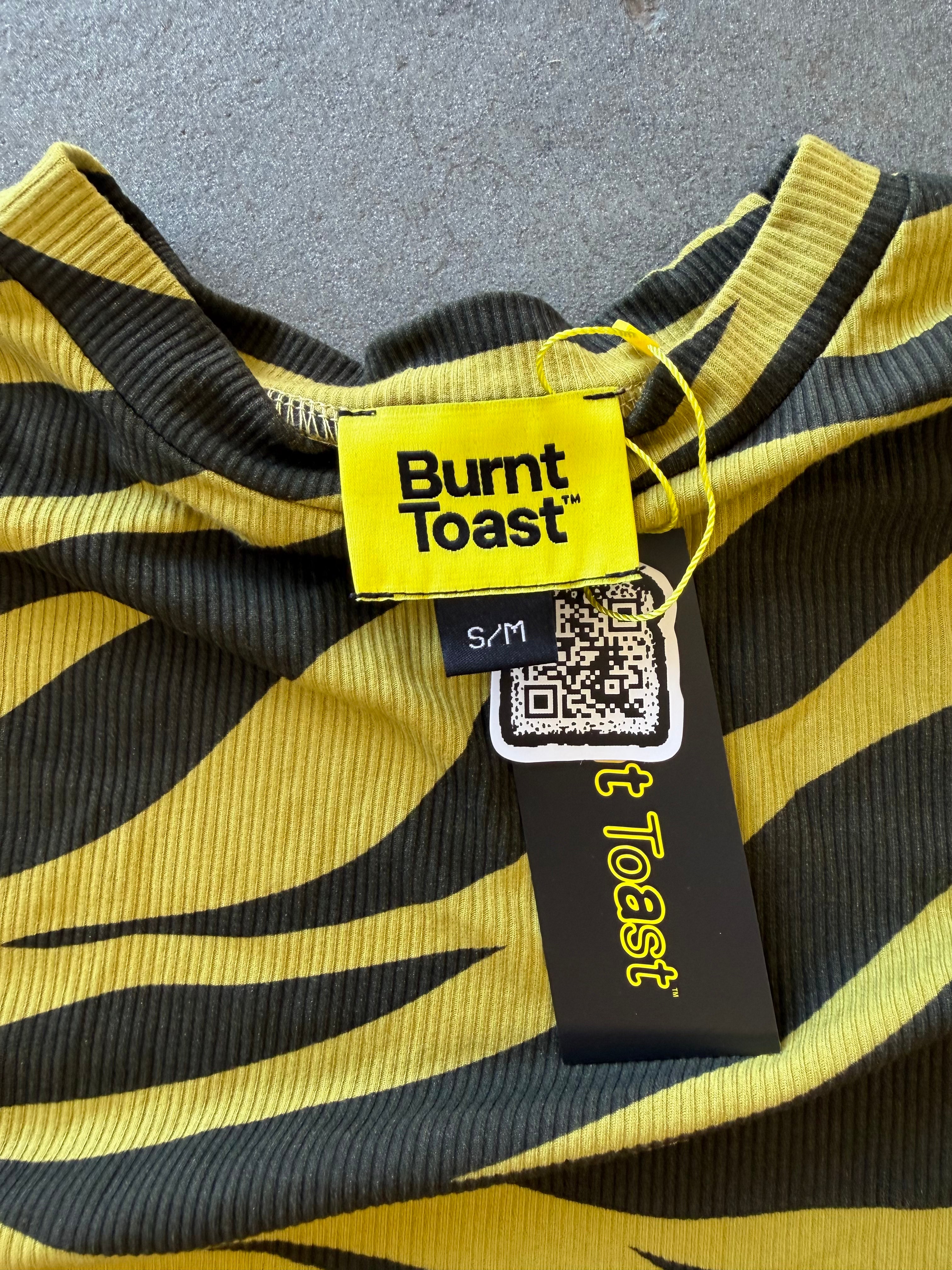 Close-up of a yellow and black striped ribbed knit garment with a visible Burnt Toast tag and size label