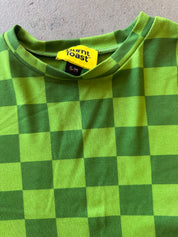 Close-up of a green and yellow checkerboard patterned shirt with a visible Burnt Toast brand label